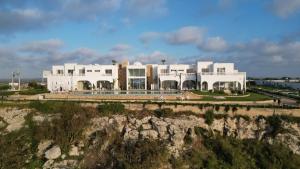 a white building on top of a cliff at Villa La Falaise in Oualidia