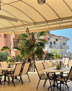 a group of tables and chairs under an umbrella at Donna in Ulcinj
