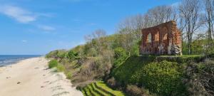 a building on a hill next to a beach at Sea View Slavia in Międzyzdroje +28 photos