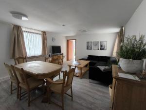 a living room with a table and a couch at FeWo Antweiler Oberdorf in Mechernich