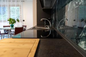 a kitchen with a sink and a counter top at Rey Residence in Nave San Felice