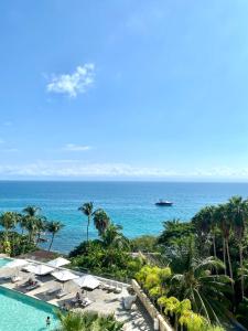 a view of the ocean from a resort with a swimming pool at Arena Bca in Cruz de Huanacaxtle