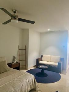 a bedroom with a bed and a couch and a table at Arena Bca in Cruz de Huanacaxtle