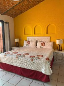 a bedroom with a bed and a yellow wall at Hotel Villas Ajijic, Ajijic Chapala Jalisco in Ajijic +135 photos