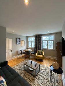a living room with a couch and a table at Brand New Flat in Central London in London