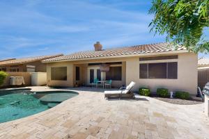 a house with a pool and a chair in the yard at Leo’s Pool & Park House in Gilbert