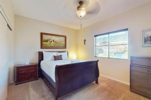 a bedroom with a bed and a dresser and a window at Leo’s Pool & Park House in Gilbert +14 photos