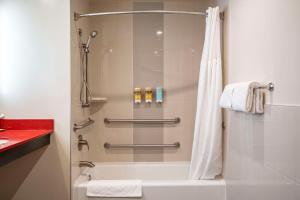 a bathroom with a shower and a bath tub at Best Western Plus Dragon Gate Inn in Los Angeles