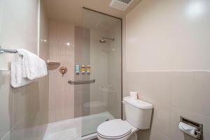 a bathroom with a toilet and a shower at Best Western Plus Dragon Gate Inn in Los Angeles