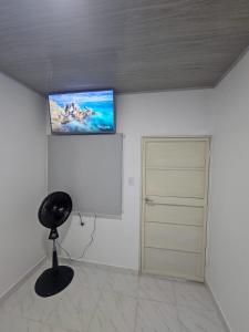 a room with a flat screen tv on the wall at La Sucursal del Cielo in Manaure Balcón del Cesar