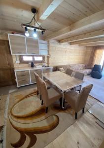 a room with a table and chairs and a bed at Villa Klodi in Boge