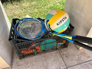 two tennis rackets and a ball in a basket at Liberty sur Moment-Ardèche-com in Lablachère