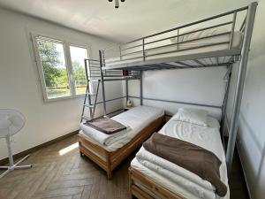 a bedroom with two bunk beds and a window at Liberty sur Moment-Ardèche-com in Lablachère +22 photos