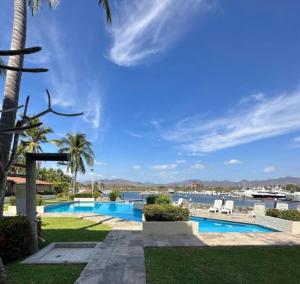 a view of the pool at a resort at Marina-Access Apartment in peaceful Ixtapa in Ixtapa