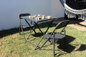 a table and two chairs with a chess game on it at casa com bela vista em Bragança Paulista in Bragança Paulista +54 photos