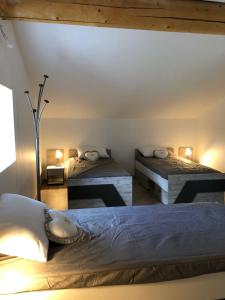 a bedroom with two beds and two tables in a room at Kinsman sur Moment-Ardèche-com in Les Vans +17 photos