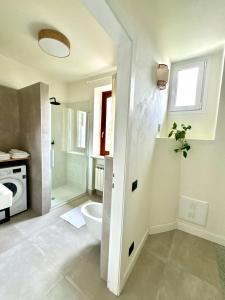 a white bathroom with a toilet and a shower at Il Cortile del Borgo in Borgo Ticino +40 photos