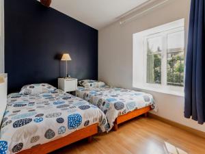 a bedroom with two beds and a window at Charmante maison au cœur du Vignoble Nantais avec wifi - FR-1-306-804 in Le Landreau