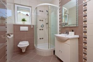a bathroom with a shower and a toilet and a sink at Apartments with parking space Kostrena, Rijeka - 23422 in Kostrena +38 photos