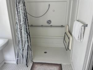 a small bathroom with a shower and a sink at Guerneville Lodge in Guerneville
