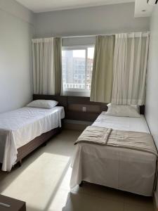 En eller flere senge i et værelse på Lagoa ECO TOWERS ao lado do parque