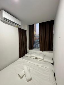 Postel nebo postele na pokoji v ubytování Lucky 88 Inn Serian + 5 fotografií