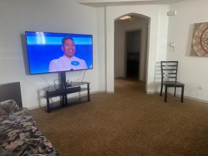 a living room with a flat screen tv on a wall at Hotel house in El Paso +1 photo