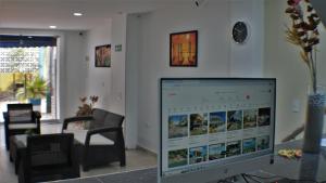 a computer monitor sitting in a living room at Hotel La Yarolina SAS in Cartagena de Indias