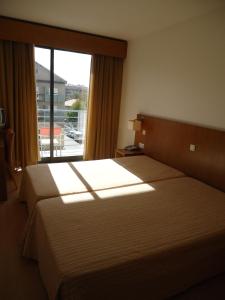 A bed or beds in a room at Hotel Jose Alberto