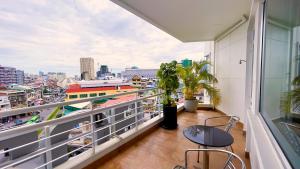 a balcony with chairs and a view of a city at Hotel Sor in Phnom Penh