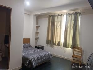 a bedroom with a bed and a window at Hospedaje Marfeb in Cieneguilla