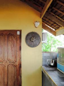 a kitchen with a yellow wall with a door at Goldsky Seaview Resort in San Juan +51 photos