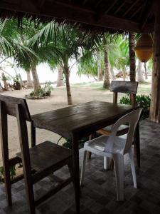 a wooden table and two chairs on a patio at Goldsky Seaview Resort in San Juan