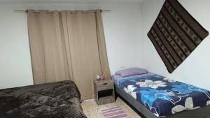 Ein Bett oder Betten in einem Zimmer der Unterkunft Misky Wasi