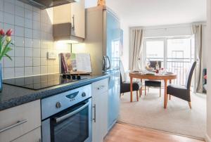 a kitchen with a table and a dining room at 2 Bed Charming Duplex in Kidlington