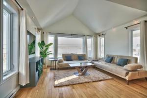 a living room with a couch and a table at Dynamite 2-Bedroom House, Garage, Sleeps 6 in Sherbrooke