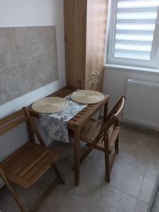 a table and a chair in a room at Casa mea in Bucharest +1 photo