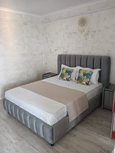 a bedroom with a large bed with two pillows at Casa mea in Bucharest