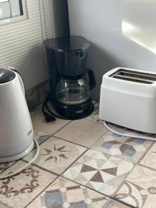 a blender sitting on a counter next to a toaster at 3H MALARGUE Monoambiente in Malargüe