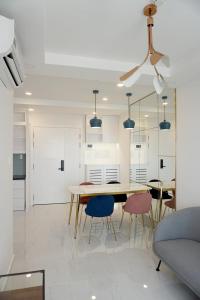 a kitchen and dining room with a table and chairs at Modern 2BR Condo at Terra Royal by Orli Studio F21 in Ho Chi Minh City +11 photos