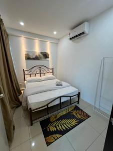 a bedroom with a bed and a air conditioner at Apartment with 2 Bedrooms, Trefoil @ Setia City (Imperia Asia Guest House) in Shah Alam