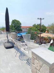 a group of chairs and a table on a patio at Ioana Apartment Siviri in Siviri