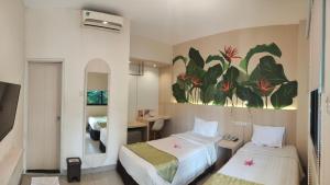 Postel nebo postele na pokoji v ubytování D'Bamboo Suites