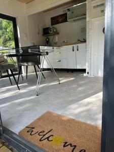 a kitchen with a table and a dining room at Tinyhaus & Souterrain Apartment in Ortenberg in Ortenberg