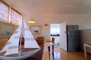 a model of a boat on a table in a kitchen at Arniston Holiday Cottage in Arniston +14 photos