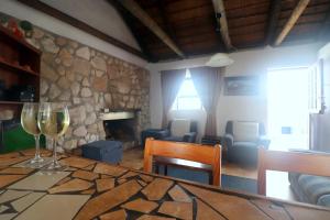 a living room with a table with two glasses of wine at Dyers House Kassiesbaai Arniston in Arniston
