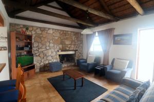 a living room with a couch and a fireplace at Dyers House Kassiesbaai Arniston in Arniston