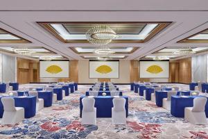 a conference room with blue tables and white chairs at Mandarin Oriental, Jakarta in Jakarta