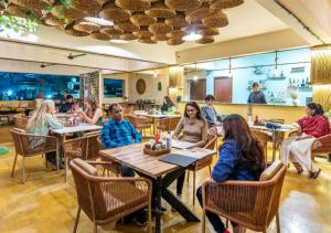 a group of people sitting at tables in a restaurant at Hotel Meerana in Jaisalmer
