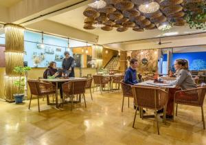 a group of people sitting at tables in a restaurant at Hotel Meerana in Jaisalmer
